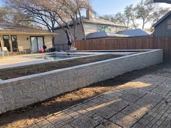 replaced coss ties with pavestone retaining wall
